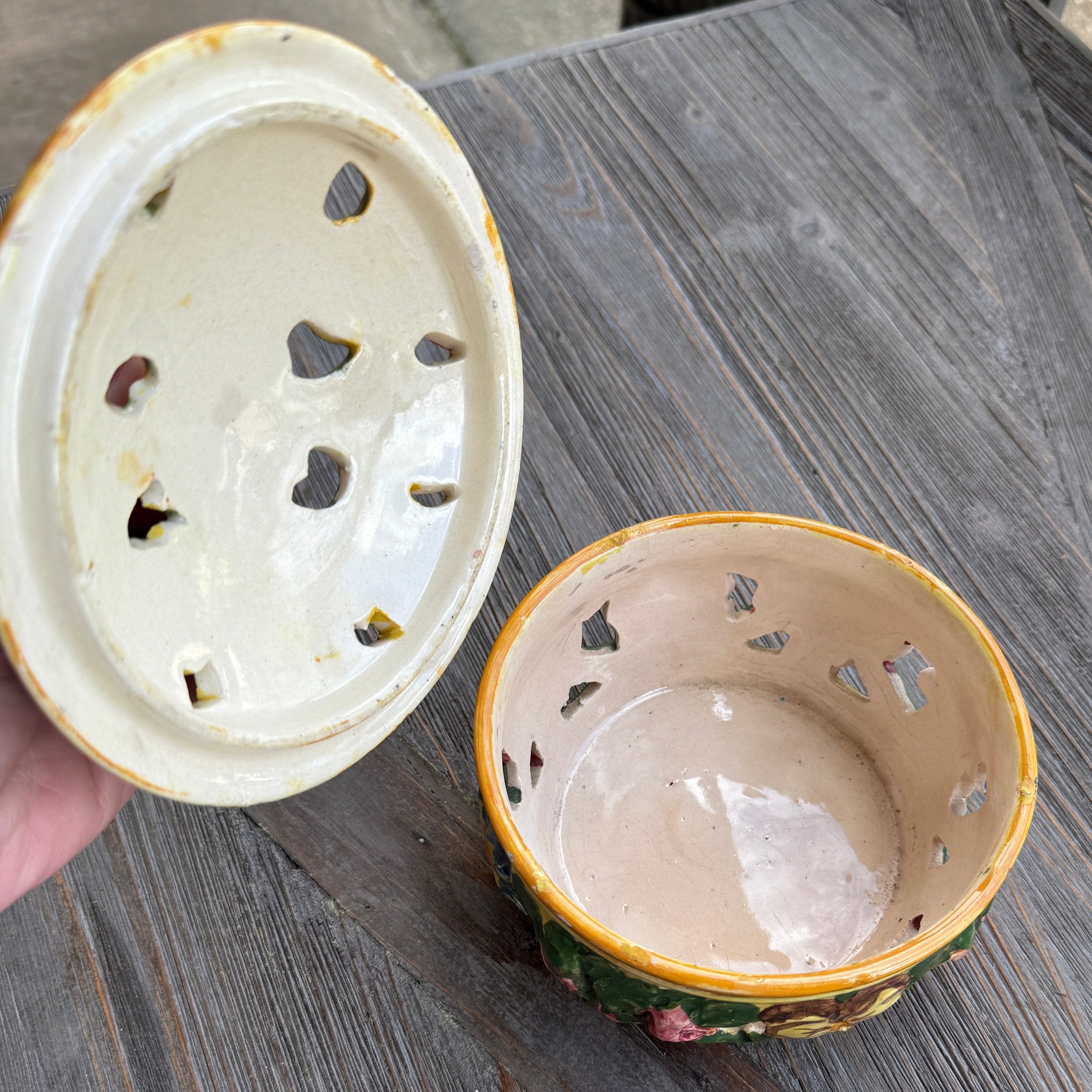 Two ceramic incense holders on a wooden surface