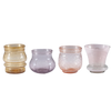 Set of four glass candle holders in different colors on a white background