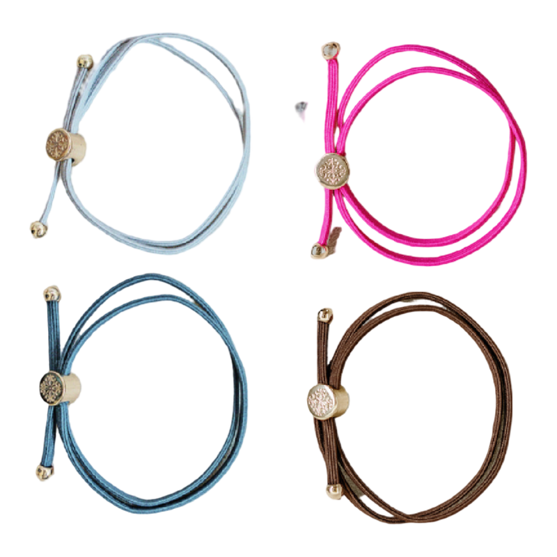 Four colorful bracelets with decorative ends on a white background