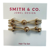 Set of hair ties with gold beads on a 'Smith & Co. Jewel Design' card.
