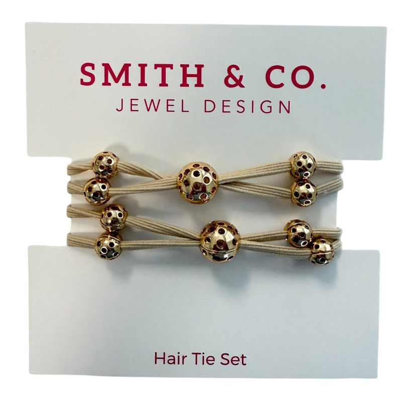 Set of hair ties with gold beads on a 'Smith & Co. Jewel Design' card.