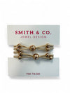 Set of gold hair ties on a Smith & Co. card