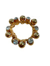 Gold ring with embedded crystals on a white background