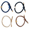 Four braided hair ties in blue, black, beige, and brown on a white background.
