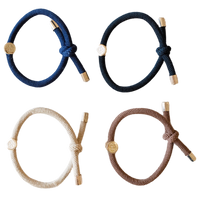 Four braided hair ties in blue, black, beige, and brown on a white background.