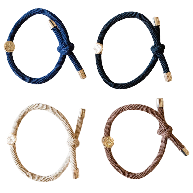 Four braided hair ties in blue, black, beige, and brown on a white background.
