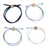Four bracelets in blue, white, and gold on a white background