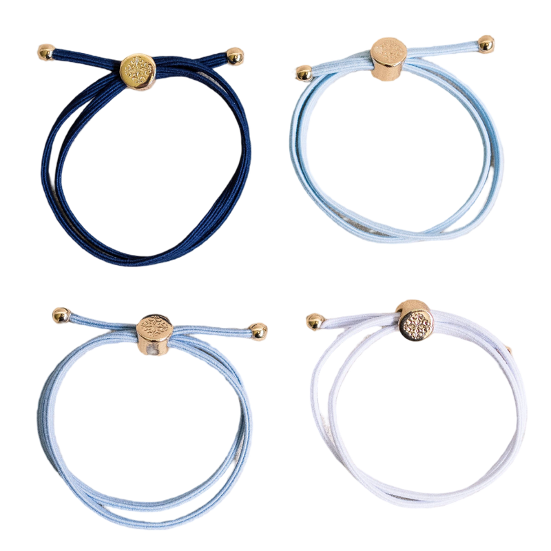 Four bracelets in blue, white, and gold on a white background