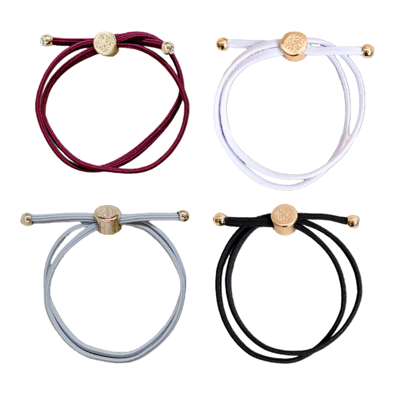 Four bracelets in red, white, gray, and black with gold accents on a white background