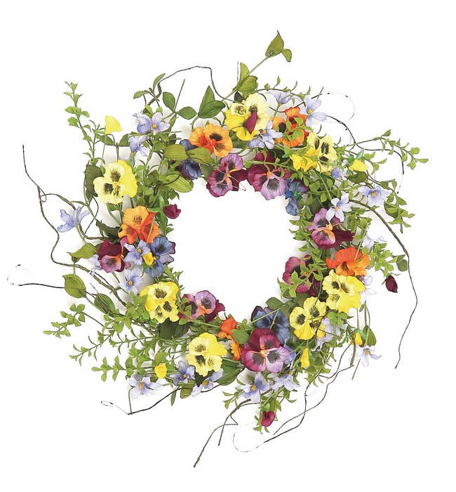 Colorful flower wreath with green leaves on a white background