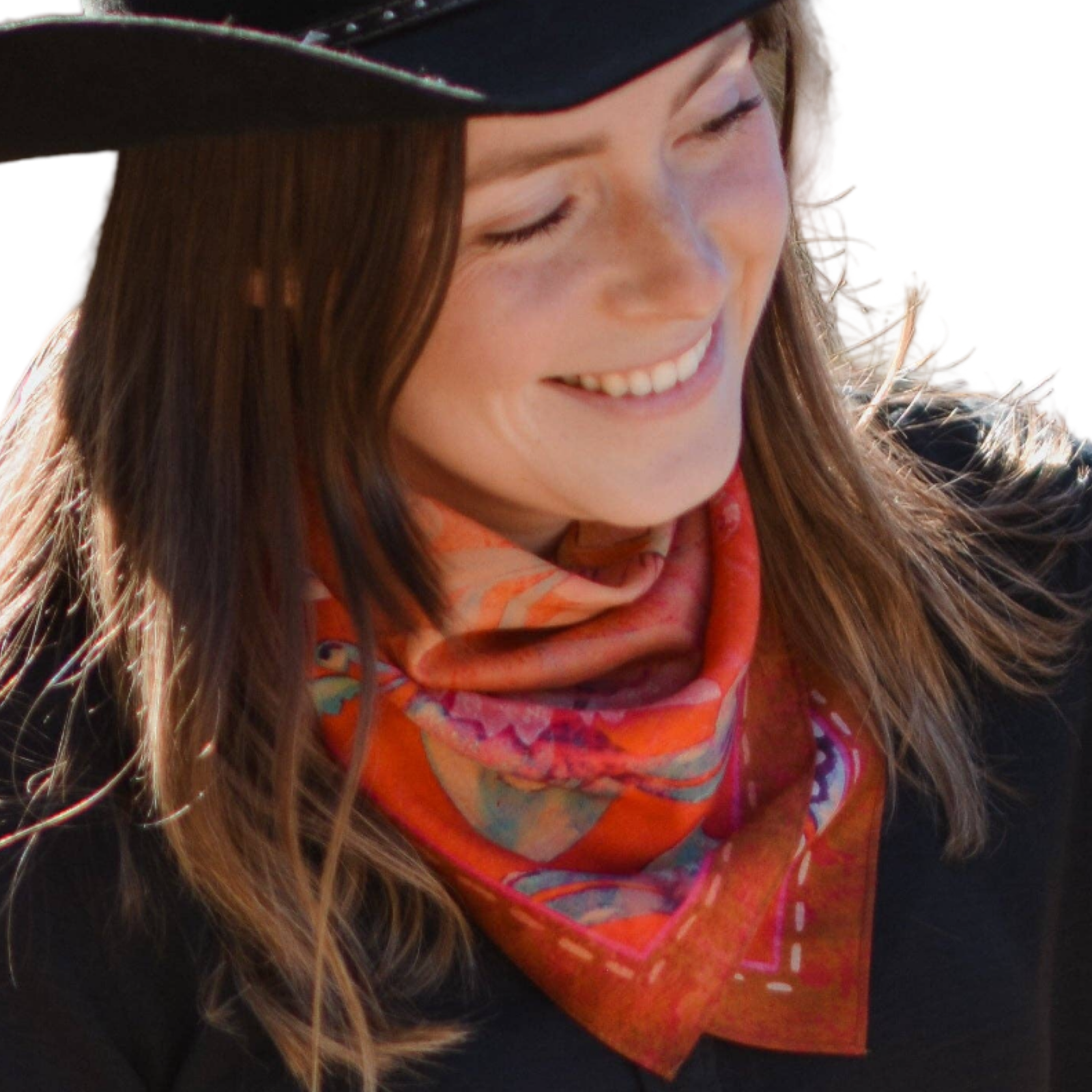 Woman wearing a colorful scarf and black hat, smiling outdoors.