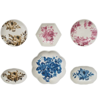 Set of six decorative plates with floral patterns on a white background
