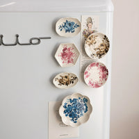Decorative plates with floral designs on a white surface
