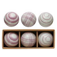 Set of six striped balls in a wooden box on a white background