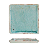 Rectangular ceramic dish with a textured turquoise glaze on a white background