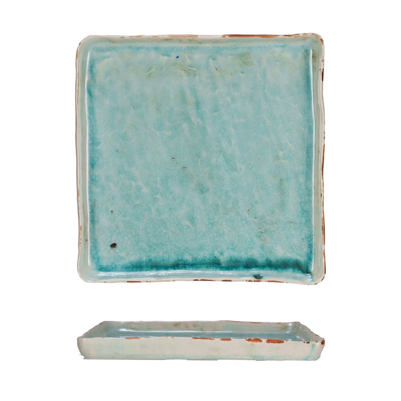 Rectangular ceramic dish with a textured turquoise glaze on a white background