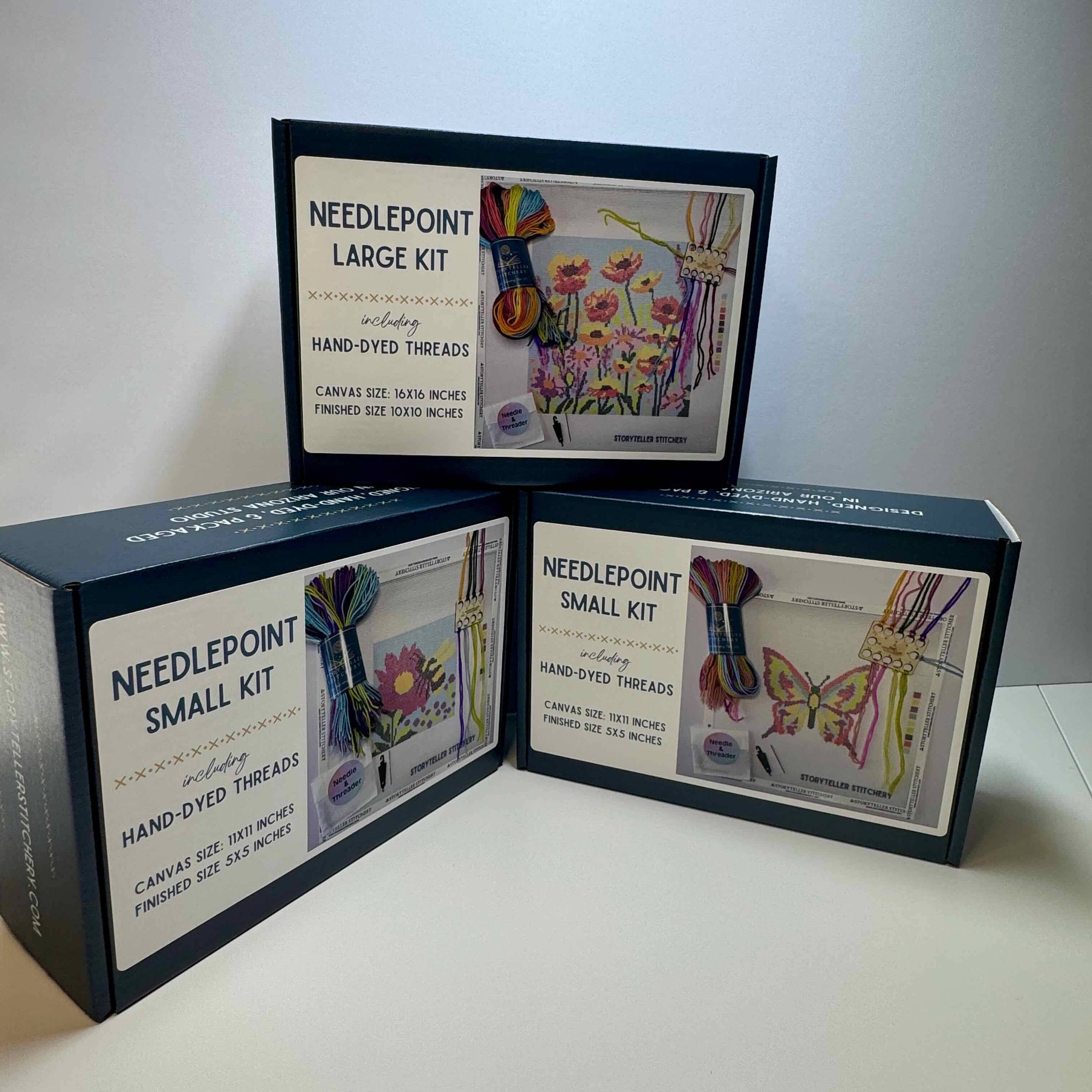 Three needlepoint kits with colorful designs on a white background