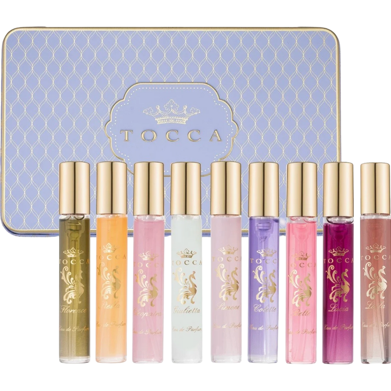 Set of Tocca perfume bottles with a decorative tin in the background