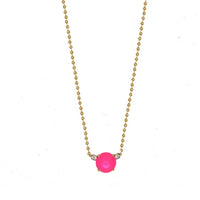 Necklace with a pink gemstone and gold chain on a white background