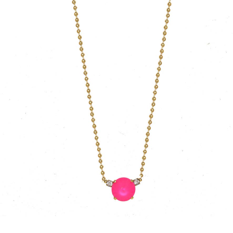 Necklace with a pink gemstone and gold chain on a white background