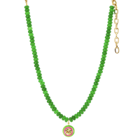 Green beaded necklace with a pink and gold pendant on a white background
