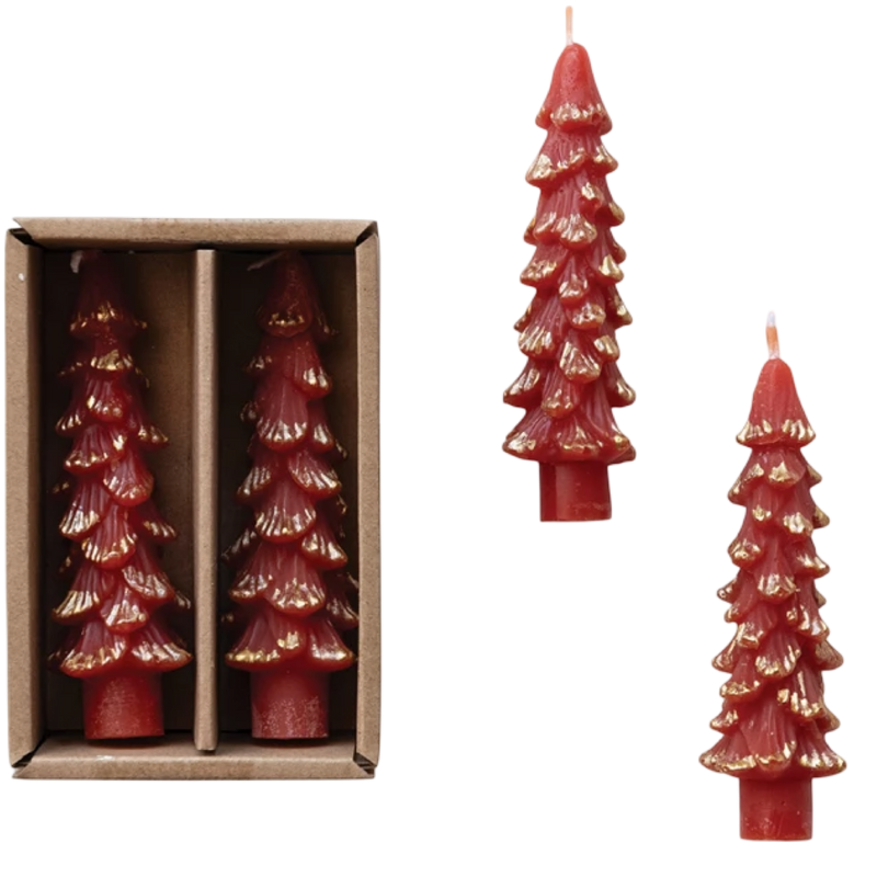 Red tree-shaped candles with gold accents in a cardboard box on a white background