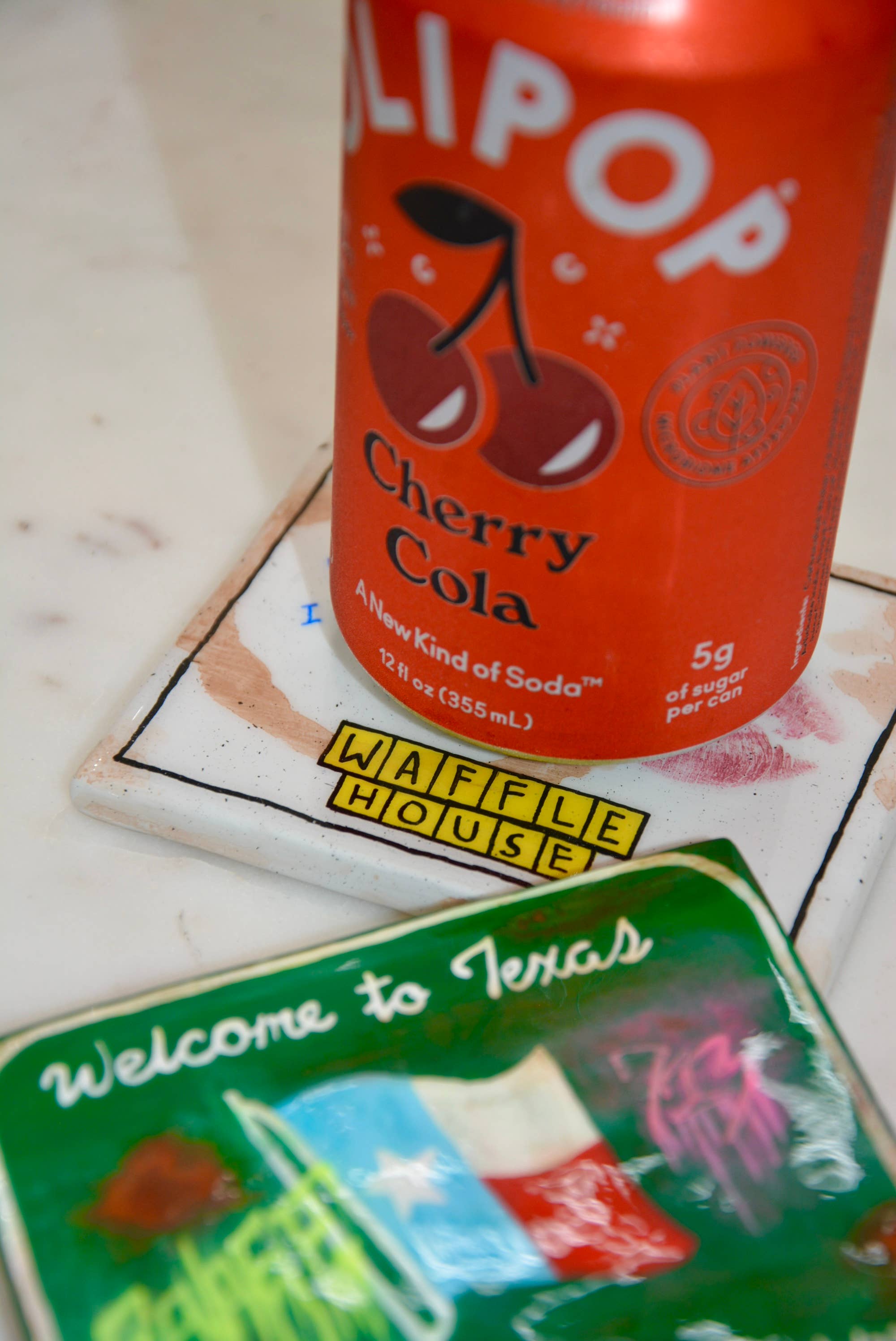 Can of LiPop Cherry Cola on a coaster with 'Waffle House' branding