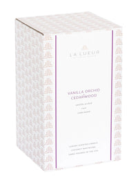 vanilla orchid cedarwood candle, floral woodsy candle, 2-wick luxury candle, purple glass candle with lid, amber musk candle scent, elegant lidded candle, cedar and vanilla home fragrance, reusable glass candle jar, warm floral scented candle, orchid musk balsam candle