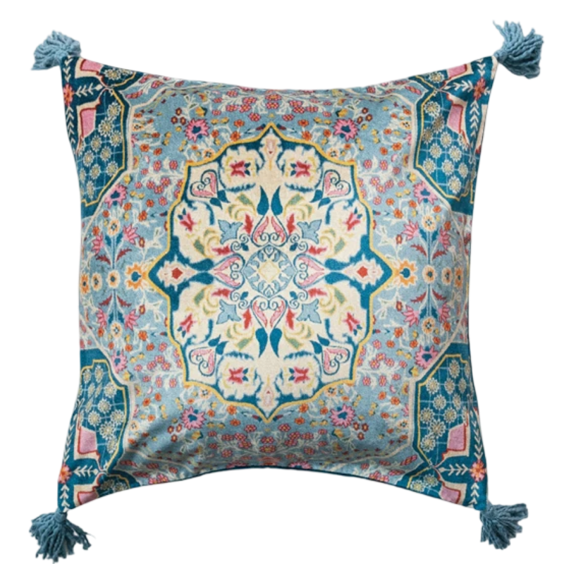 Decorative pillow with intricate floral pattern and tassels on a white background