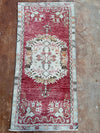 Decorative rug with intricate patterns on a brown floor