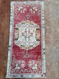 Decorative rug with intricate patterns on a brown floor