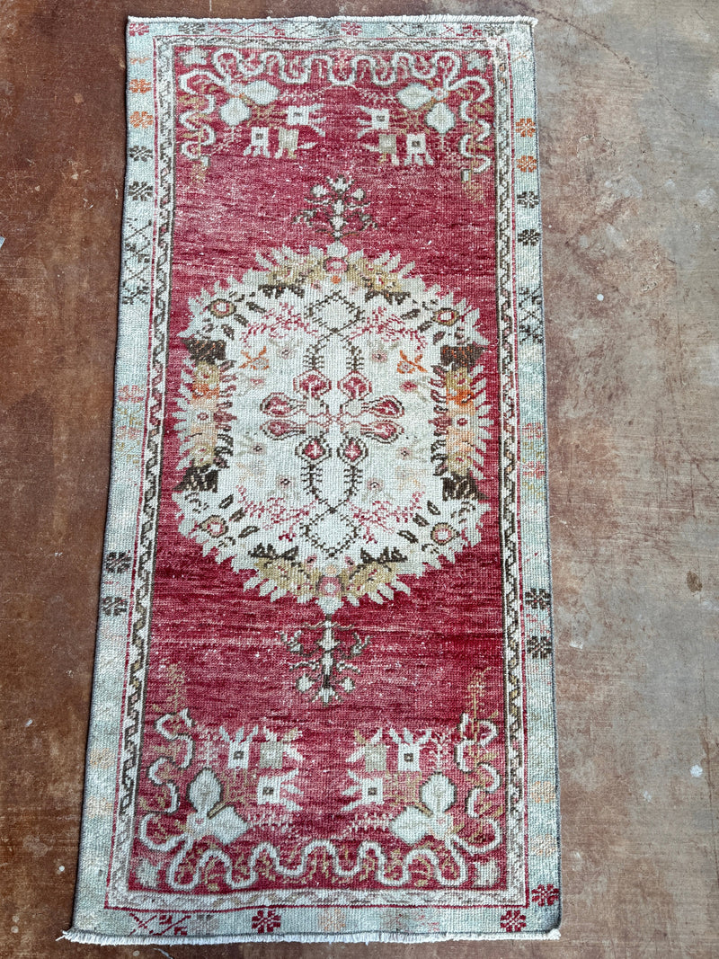 Decorative rug with intricate patterns on a brown floor