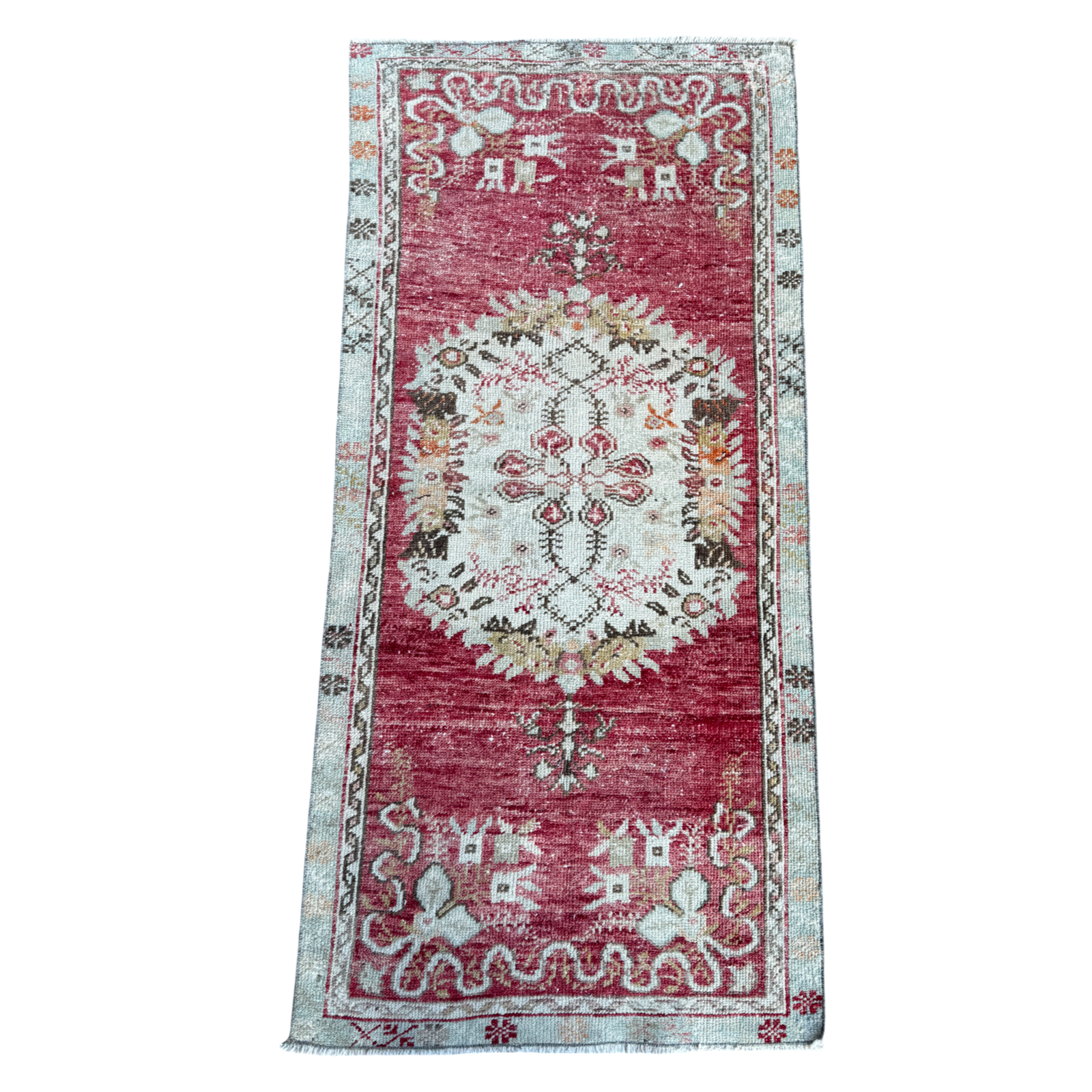 Decorative rug with intricate patterns on a white background