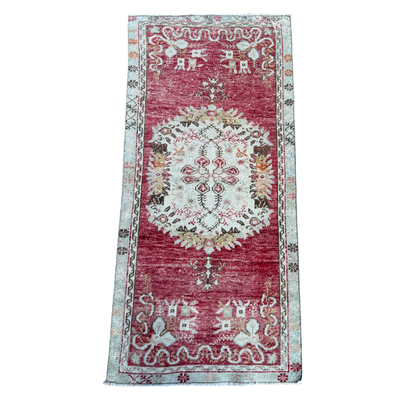 Decorative rug with intricate patterns on a white background