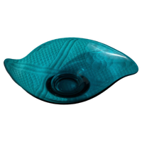 Teal glass bowl with textured surface on a white background