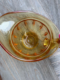 Clear glass with gold interior on a wooden surface