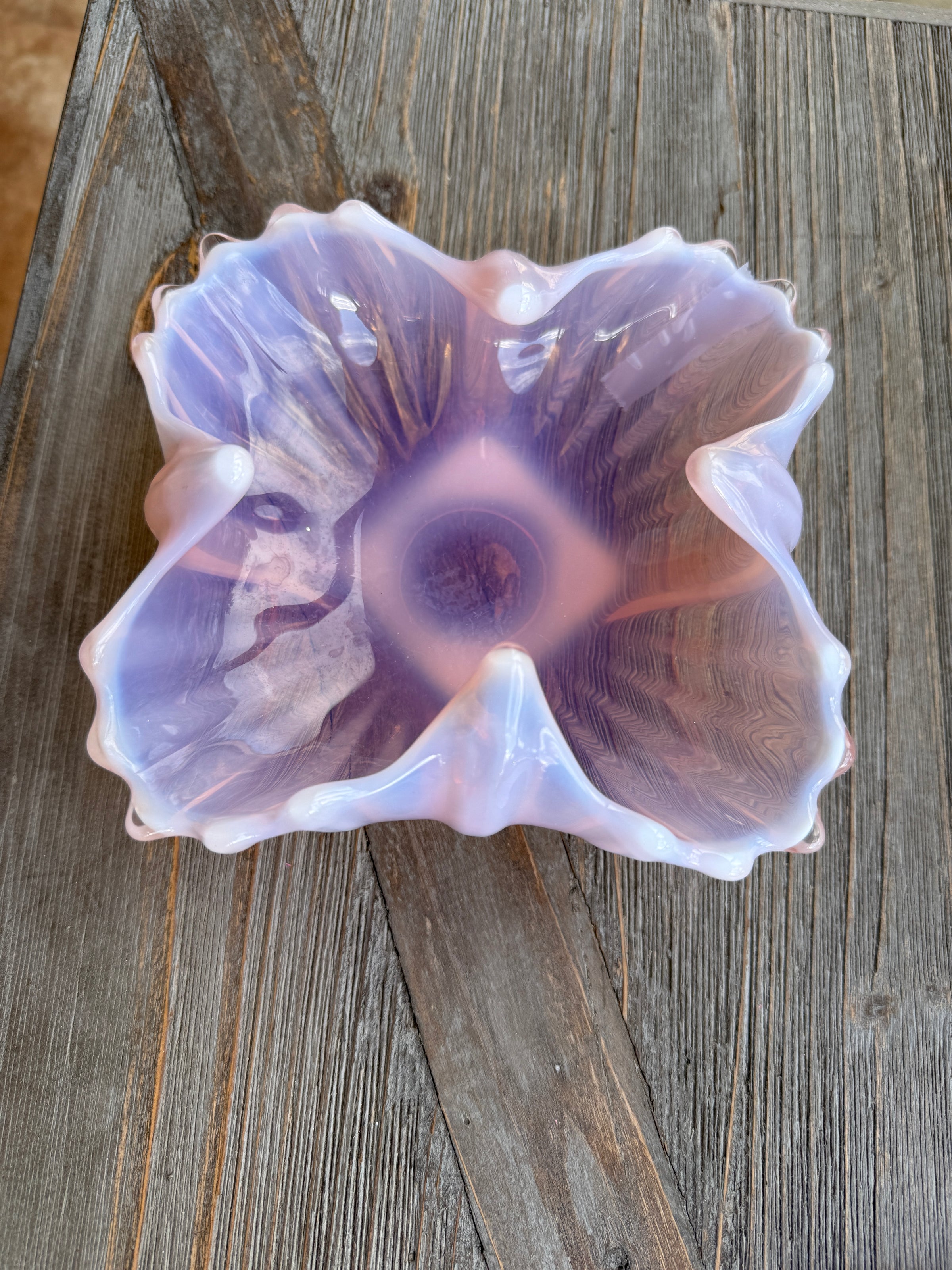 Decorative glass bowl with a floral pattern on a wooden surface