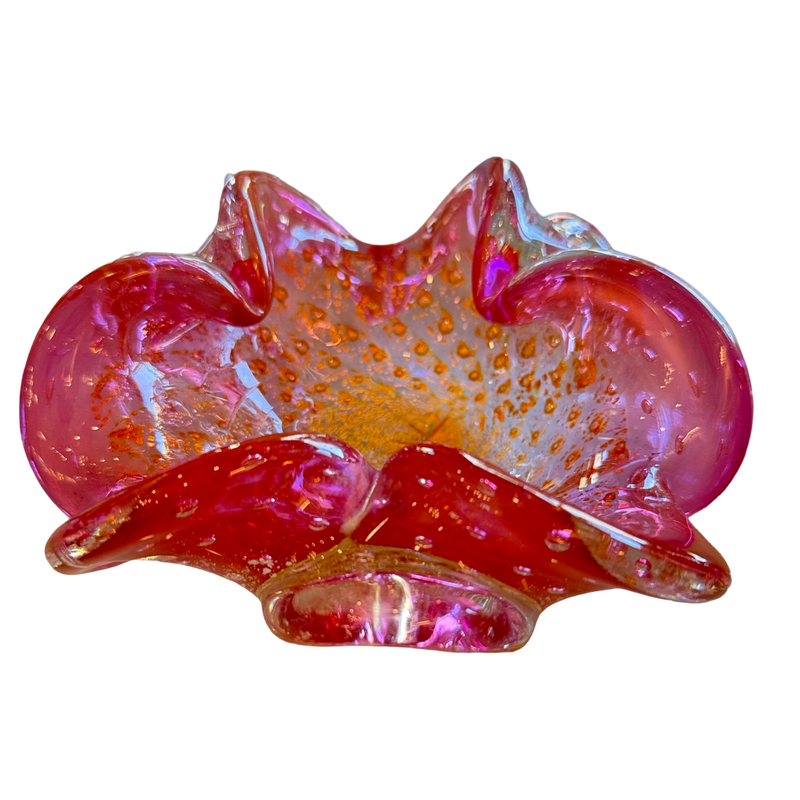 Pink and orange glass bowl with textured surface on a white background