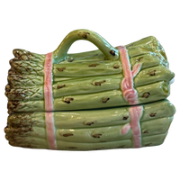 Ceramic log-shaped object with a handle on a white background