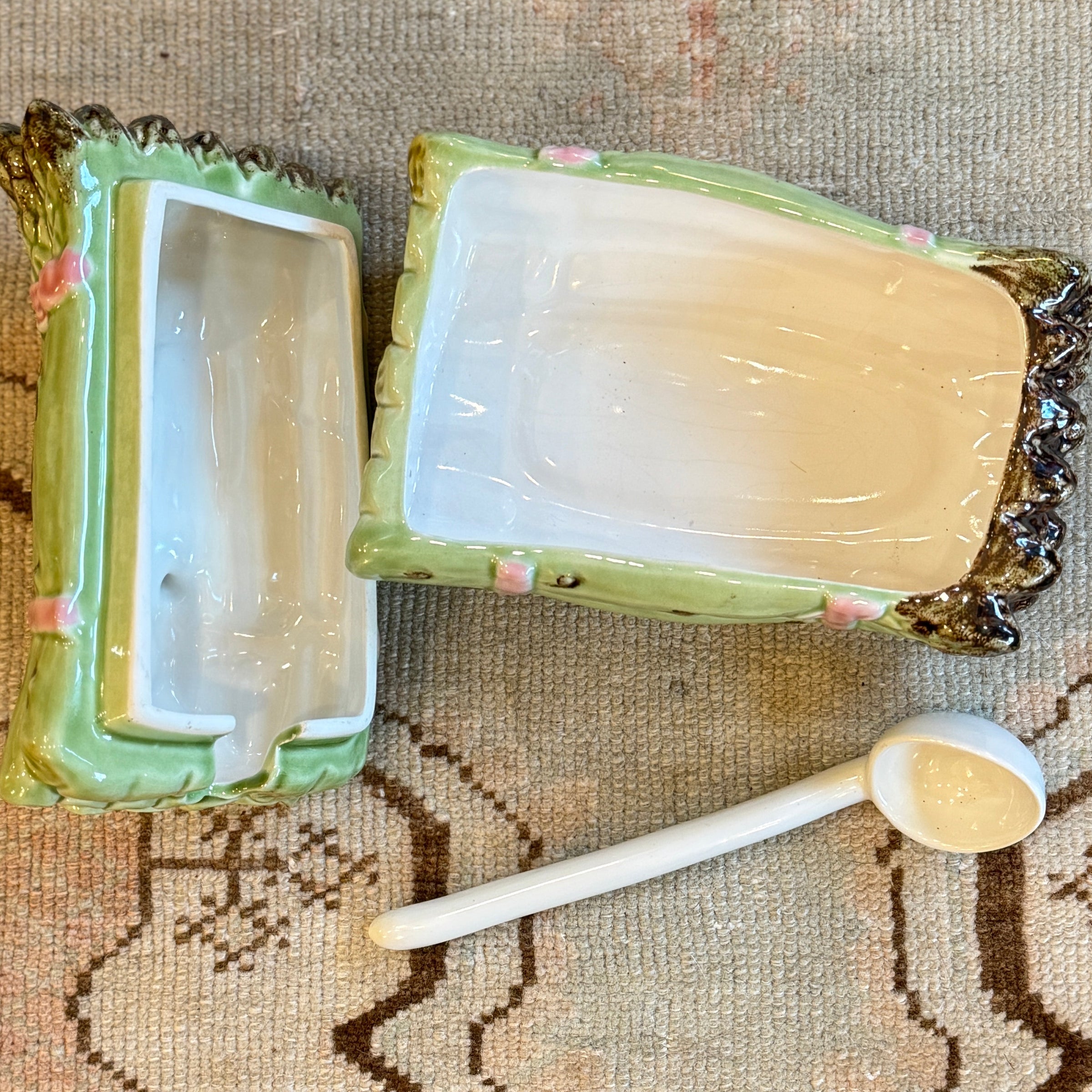 Decorative ceramic box with a spoon on a textured fabric background