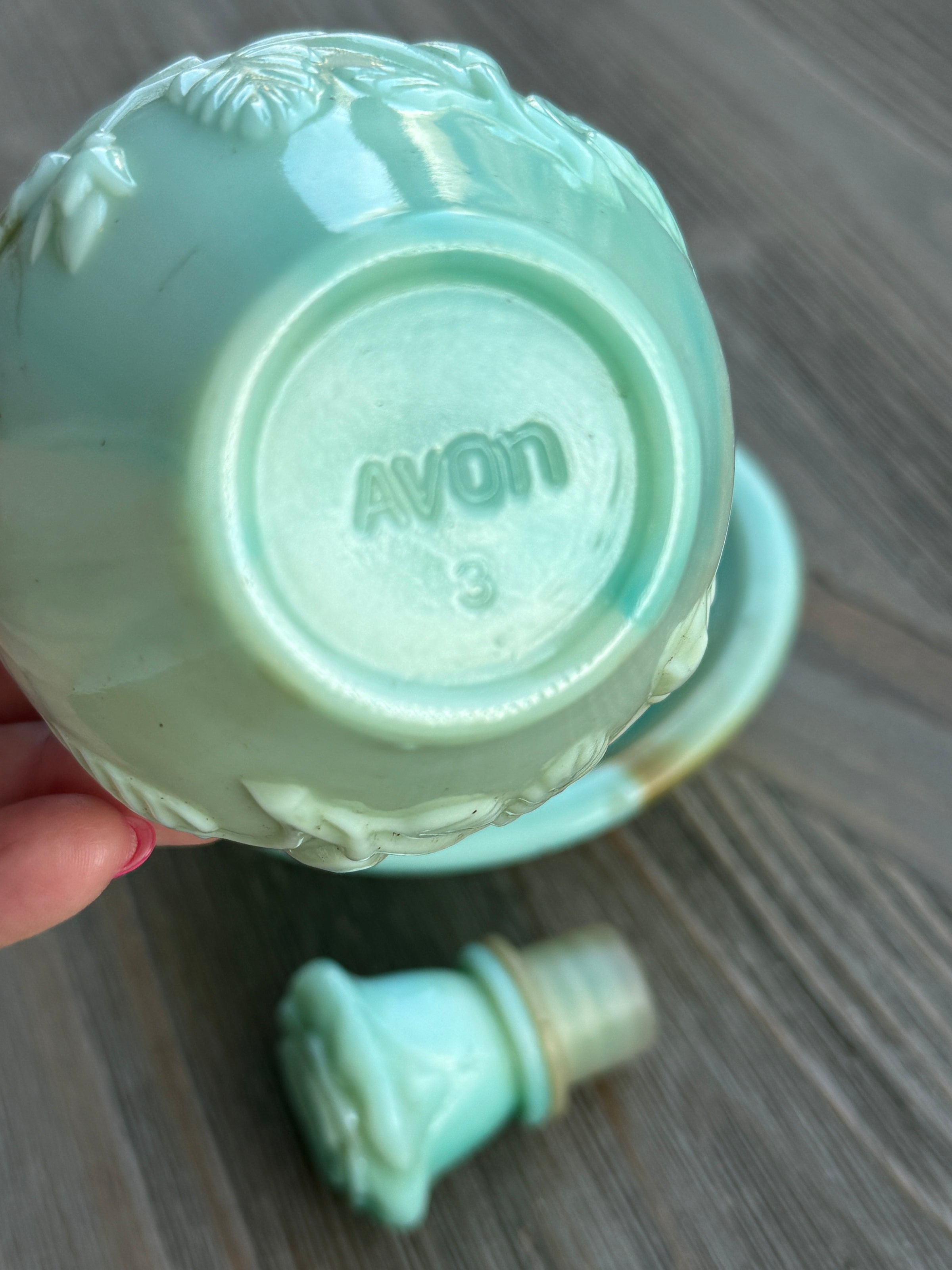 Turquoise ceramic container with lid on a wooden surface