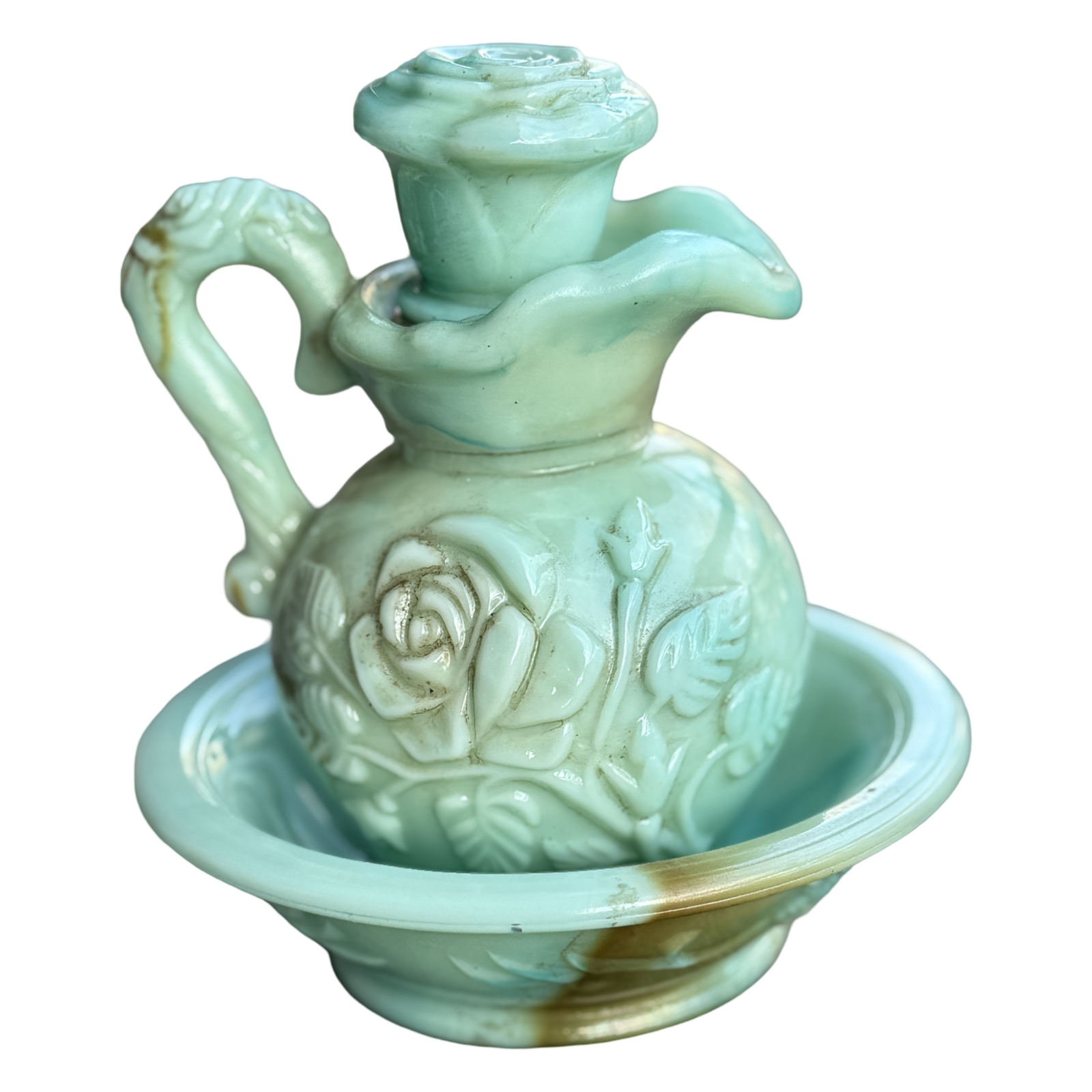 Decorative ceramic oil lamp with floral designs on a white background