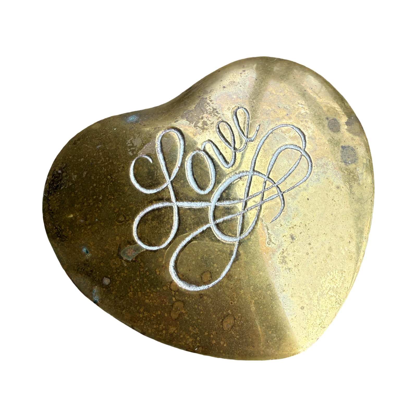 Heart-shaped brass object with 'Love' engraved on a white background