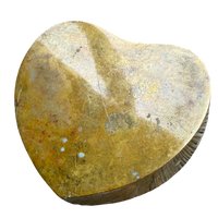 Heart-shaped stone with a rough texture on a white background