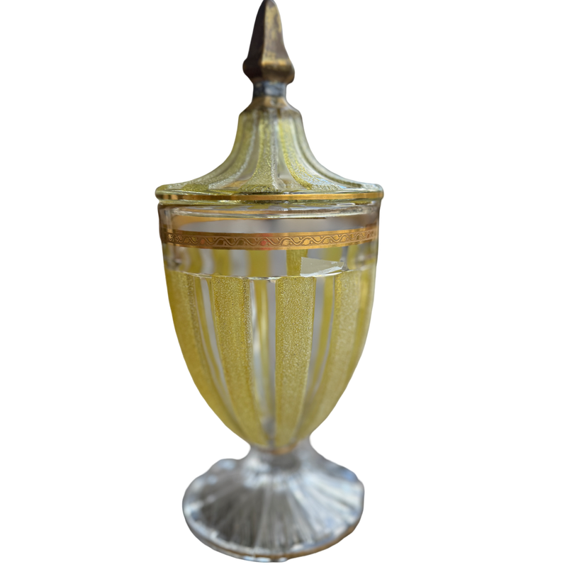 Decorative glass urn with gold accents on a white background