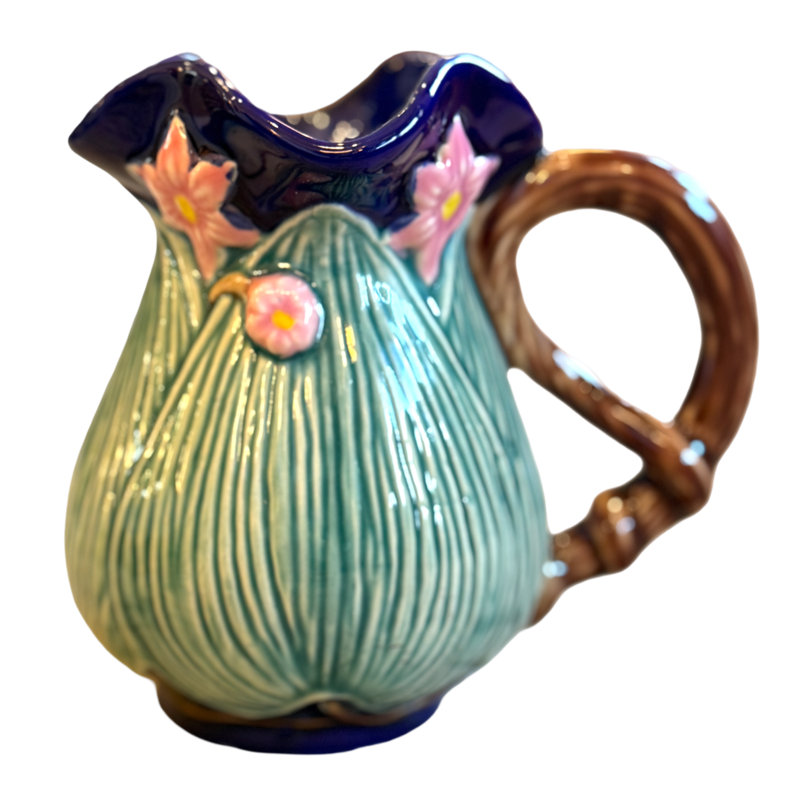 Ceramic pitcher with floral design on a white background