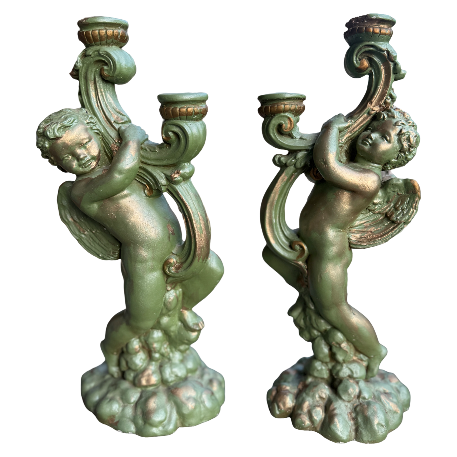 Two decorative candle holders shaped like cherubs on a white background
