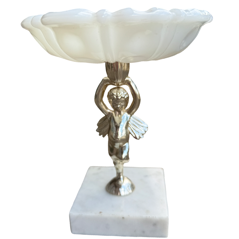 Decorative lamp with a cherub figure on a marble base against a white background