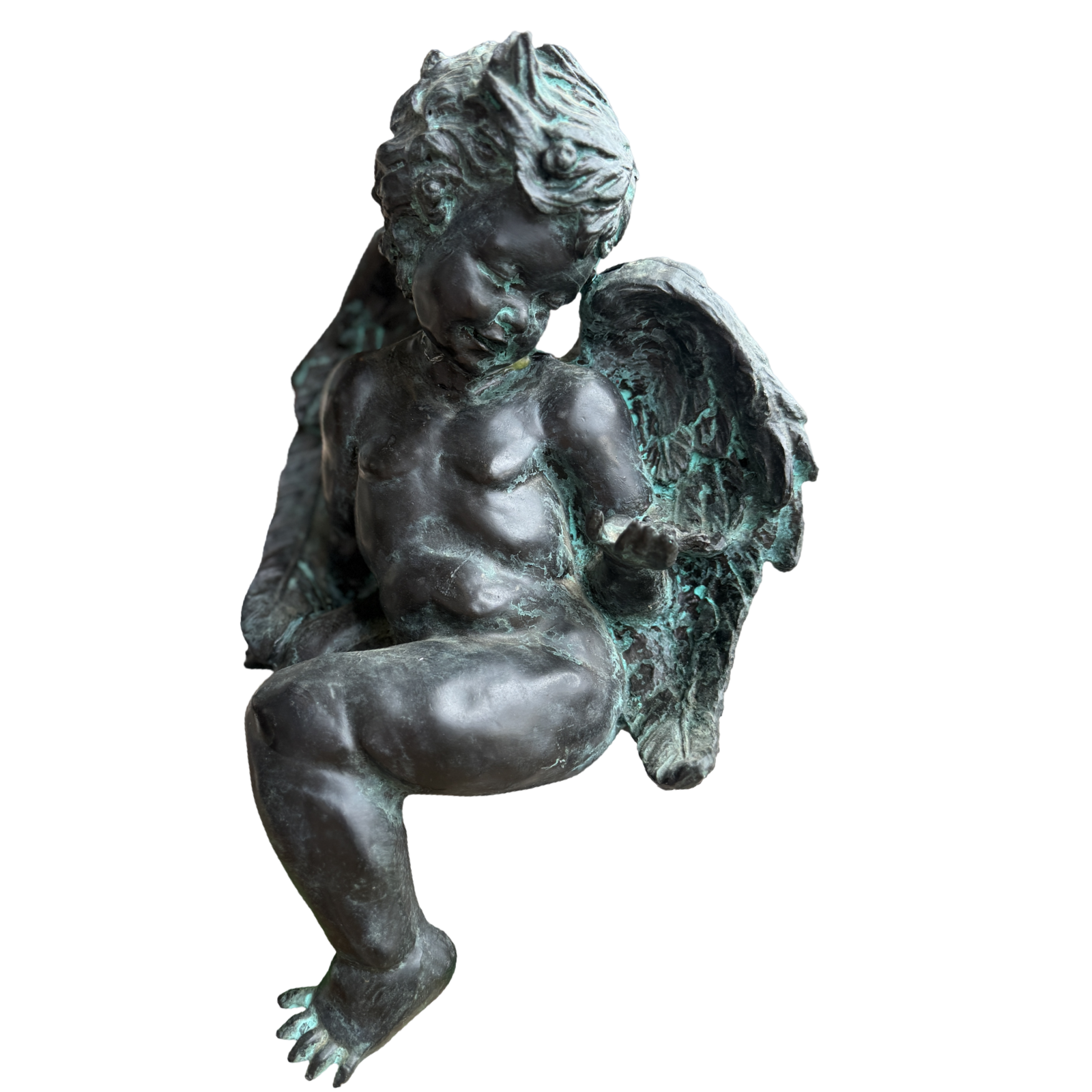 Bronze statue of a winged child on a white background