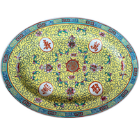 Vintage Famille Jaune Chinese porcelain platter with yellow background, floral motifs, scrolling pattern details, and colorful geometric border. One-of-a-kind chinoiserie decorative accent for shelves, walls, or tabletops.